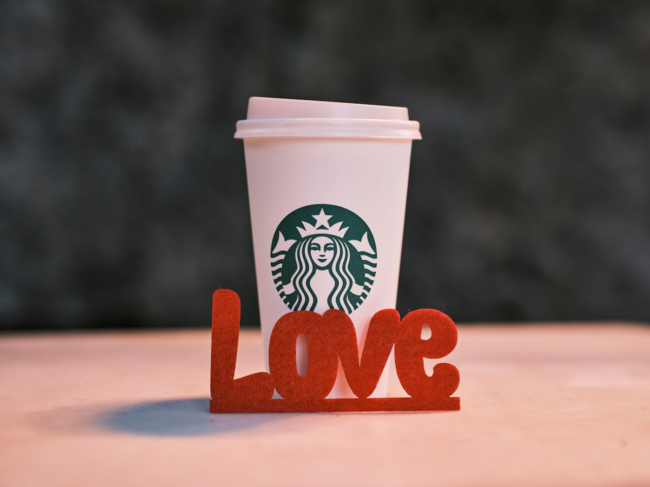 Close-up of a coffee cup with 'Love' decoration creating a warm, romantic vibe.