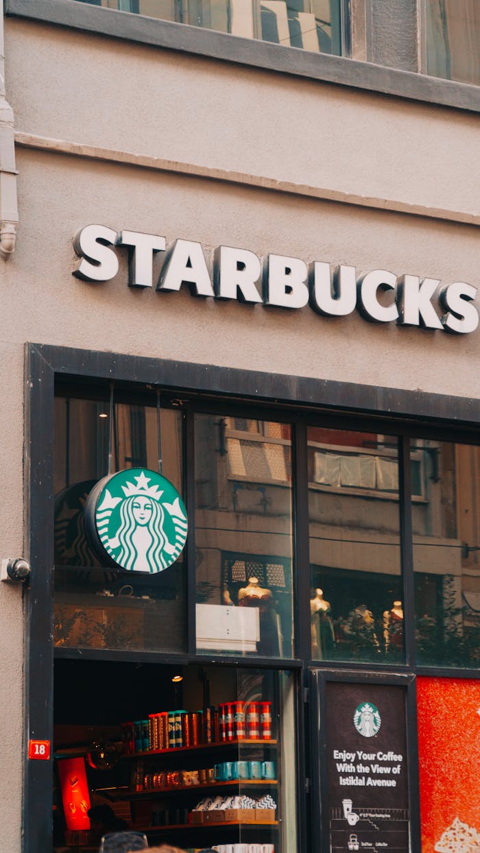 Crafting Captivating Headlines: Your awesome post title goes here View of a Starbucks coffee shop with glass windows and signage in a bustling street.